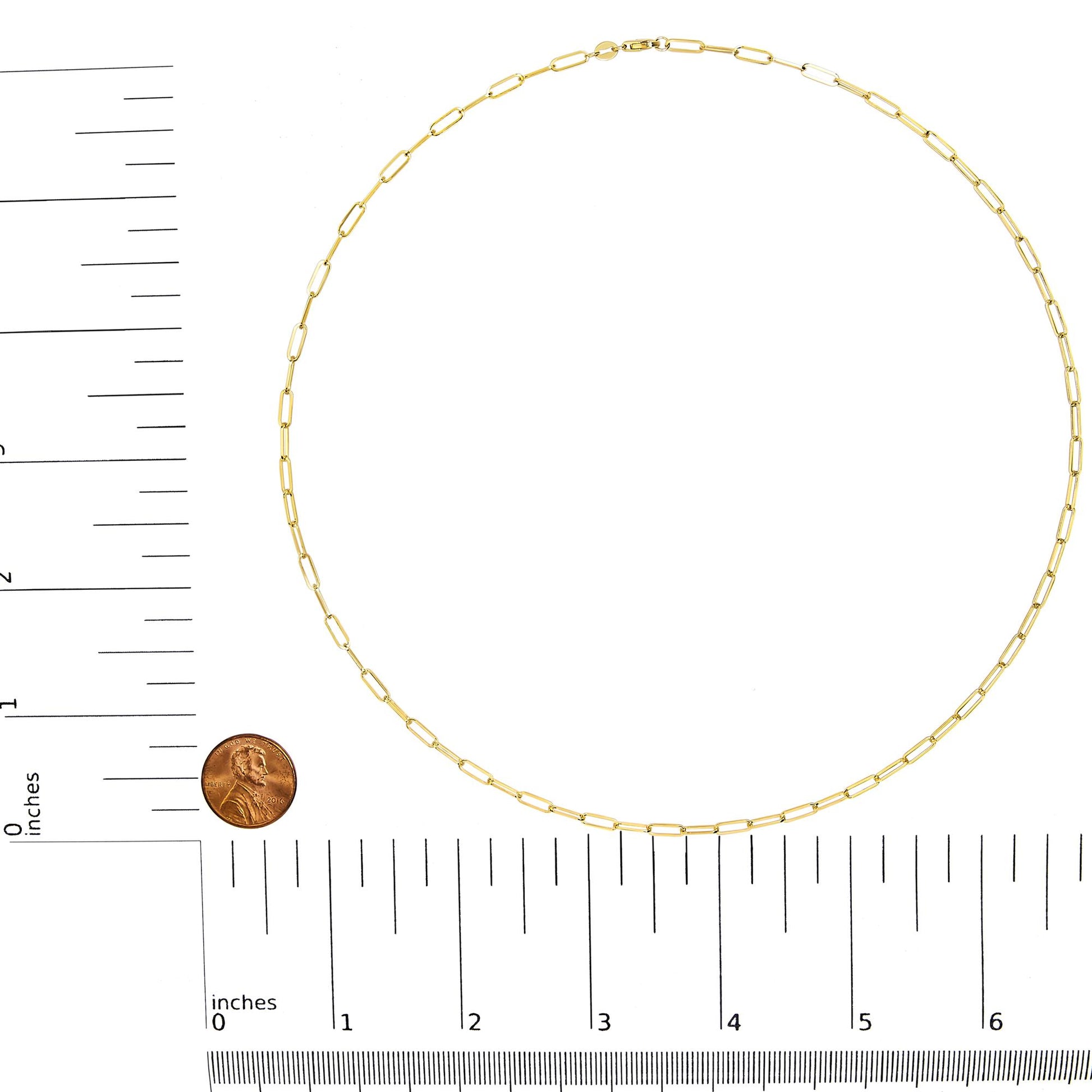 Top view of a yellow chain necklace with elongated rectangular links, shown on a ruler and scale for size reference.