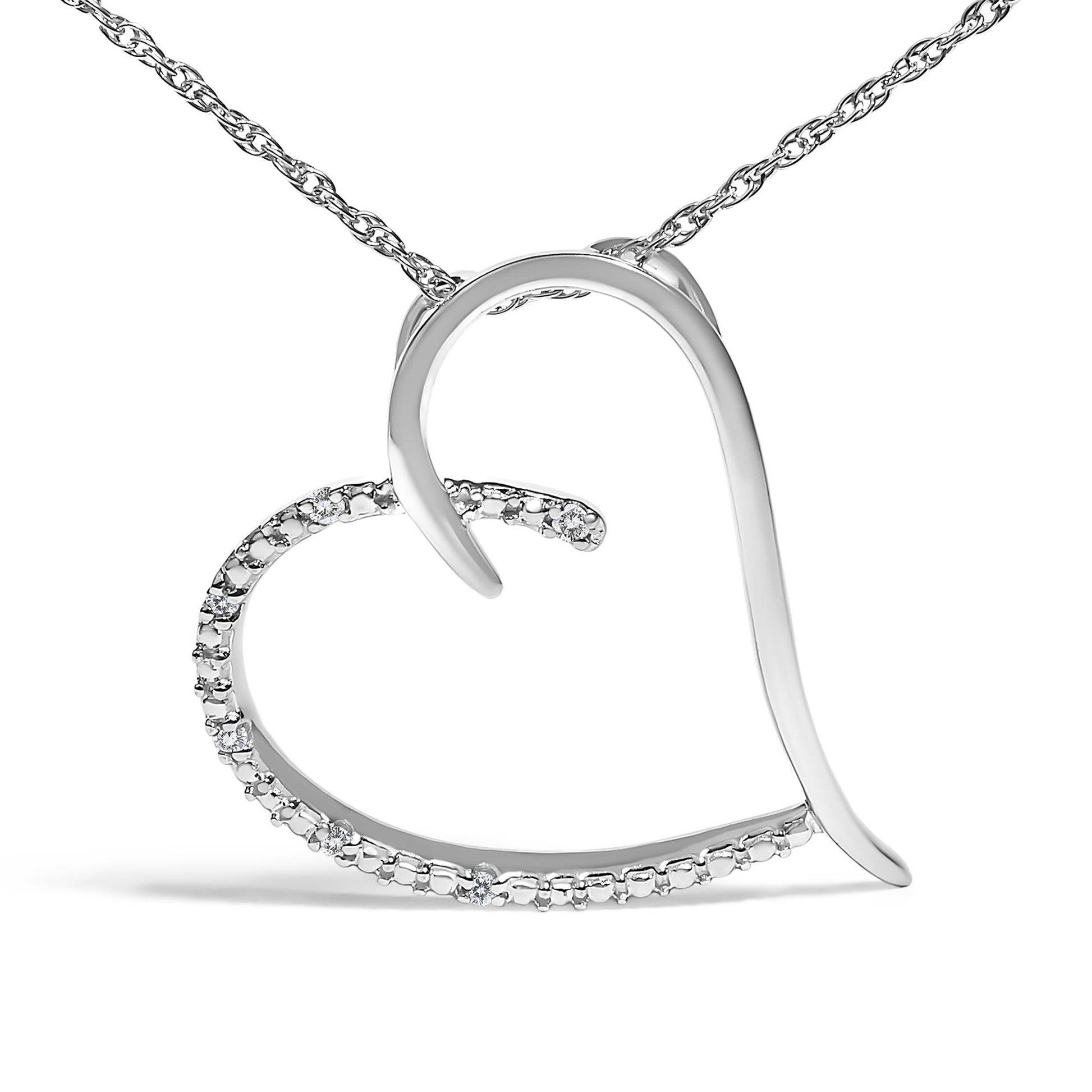 White metal heart-shaped necklace pendant with partial round white gemstones in prong setting, shown from front angle.