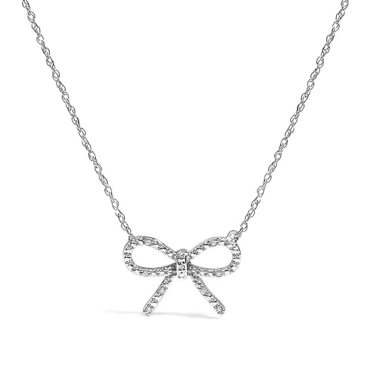 Front view of a white metal necklace with a bow-shaped pendant adorned with round white gemstones in prong settings.