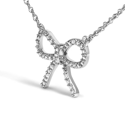 Close-up front angle of a white-colored metal necklace featuring a bow-shaped pendant adorned with round white gemstones in prong settings.