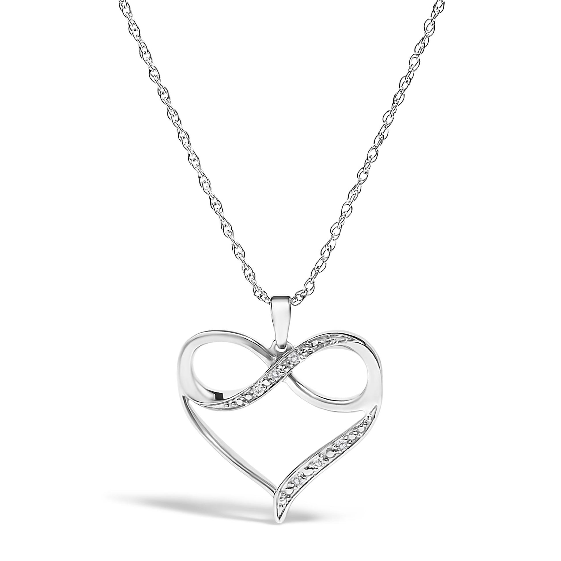 Front angle view of a white metal necklace with an open heart-shaped pendant featuring a twisted design studded with white round prong-set gemstones.