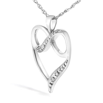 Close-up front angle of a white metal heart-shaped necklace pendant with two curved bands set with round white gemstones, hanging from a chain.