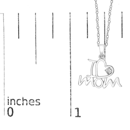 White metal necklace pendant with 'I ♥ mom' design, featuring one round white gemstone in the heart, shown against a ruler for size reference, front angle.