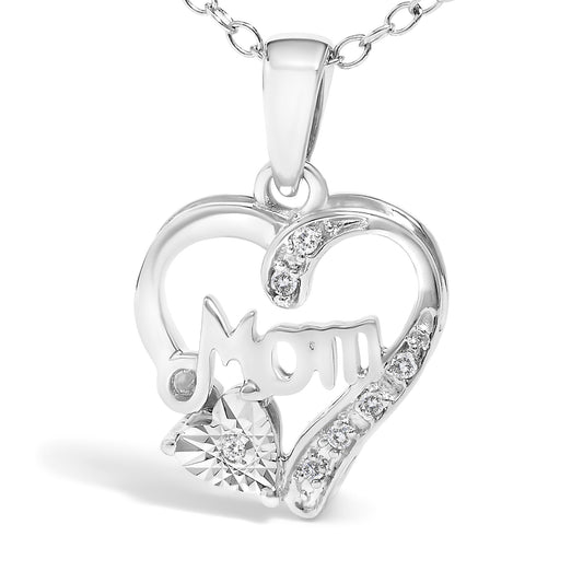 Close-up front angle of a white metal heart-shaped necklace pendant with the word 'Mom' inside, adorned with round white gemstones in prong settings along the right side and a heart-shaped cluster of white gemstones at the bottom left.