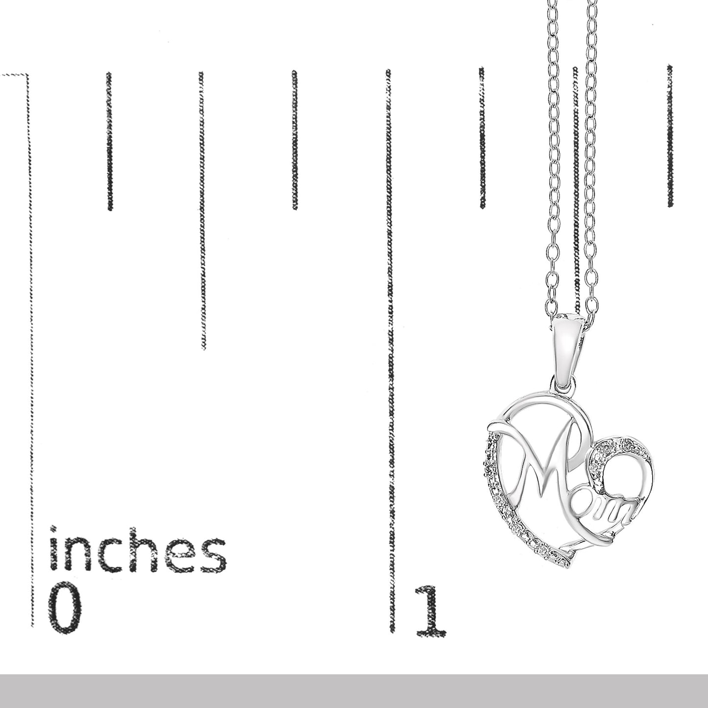 White metal heart-shaped necklace pendant with 'Mom' lettering, accented with white round gemstones, shown hanging against a ruler for size reference, front view.