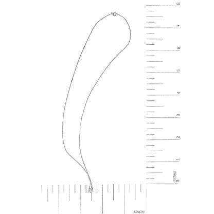 White necklace with a round white gemstone in a four-prong setting, shown lying flat on a scale in a top-down angle.