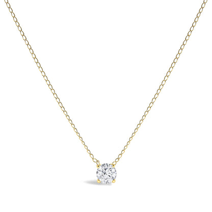 Front-facing shot of a yellow metal necklace with a single round white gemstone in a four-prong setting pendant.