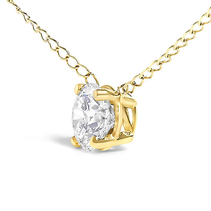 Close-up angled view of a yellow metal necklace with a round white gemstone in a four-prong setting.
