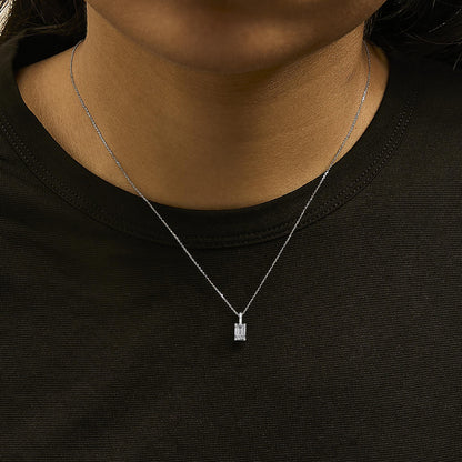 Close-up front view of a model wearing a white metal necklace with a rectangular-shaped white gemstone pendant in a four-prong setting.