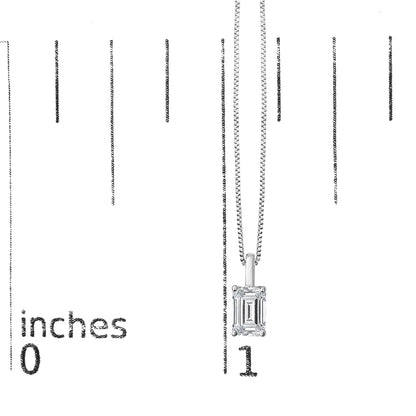 Close-up front view of a white necklace with a single emerald-shaped white gemstone pendant shown on a scale.