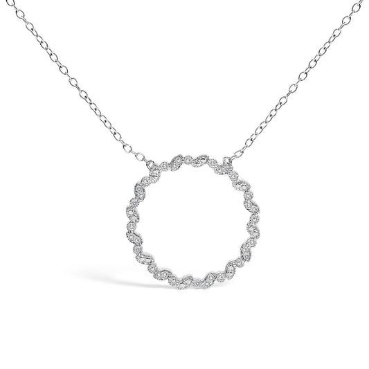 Front-facing shot of a white metal necklace with a circular pendant featuring round white gemstones in prong settings forming a continuous loop.