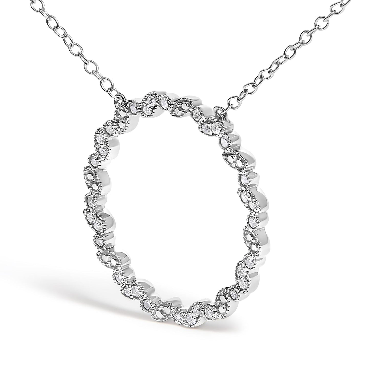 White metal necklace with a circular pendant featuring a wavy pattern set with round white gemstones, shown at a slight front angle.