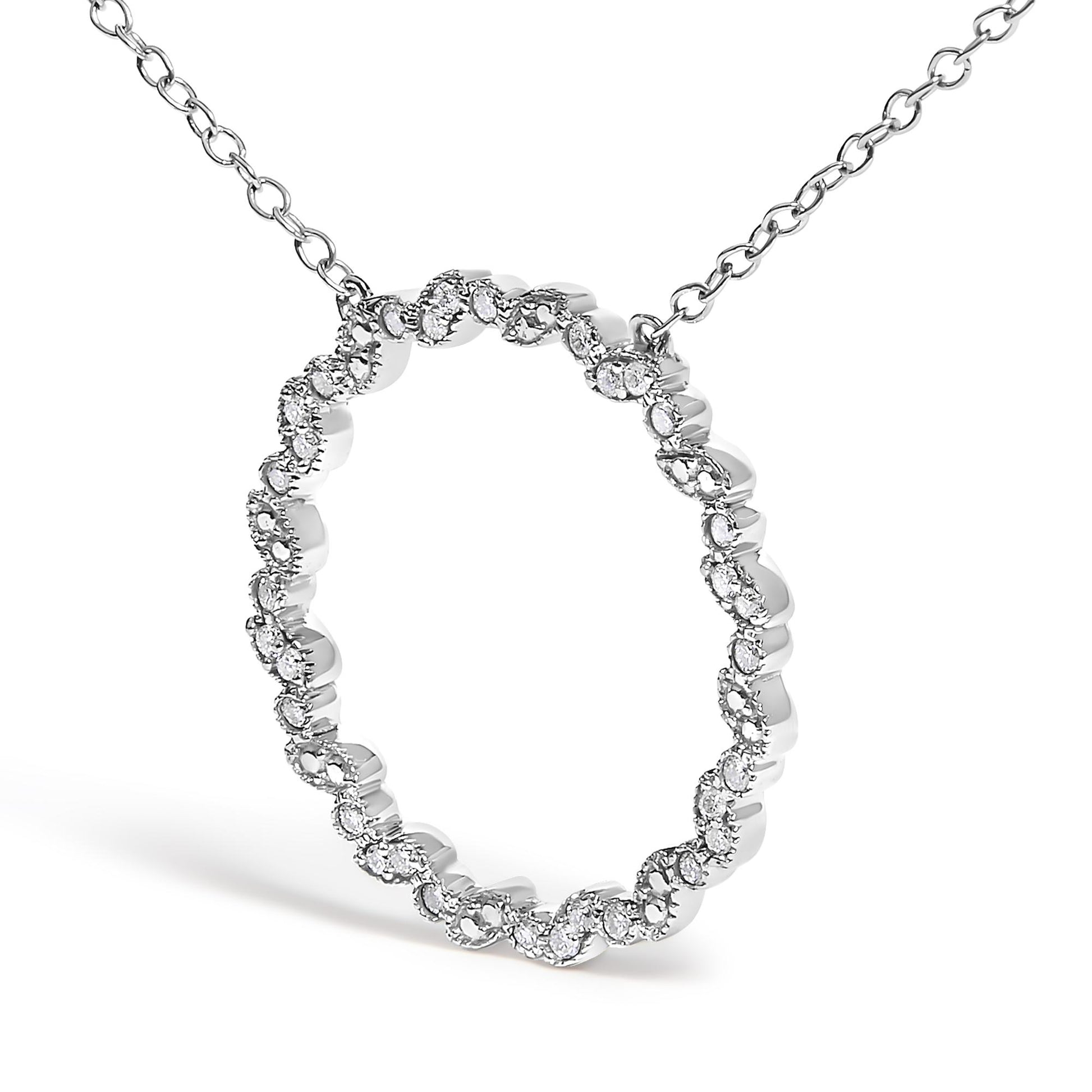 White metal necklace with a circular pendant featuring a wavy pattern set with round white gemstones, shown at a slight front angle.