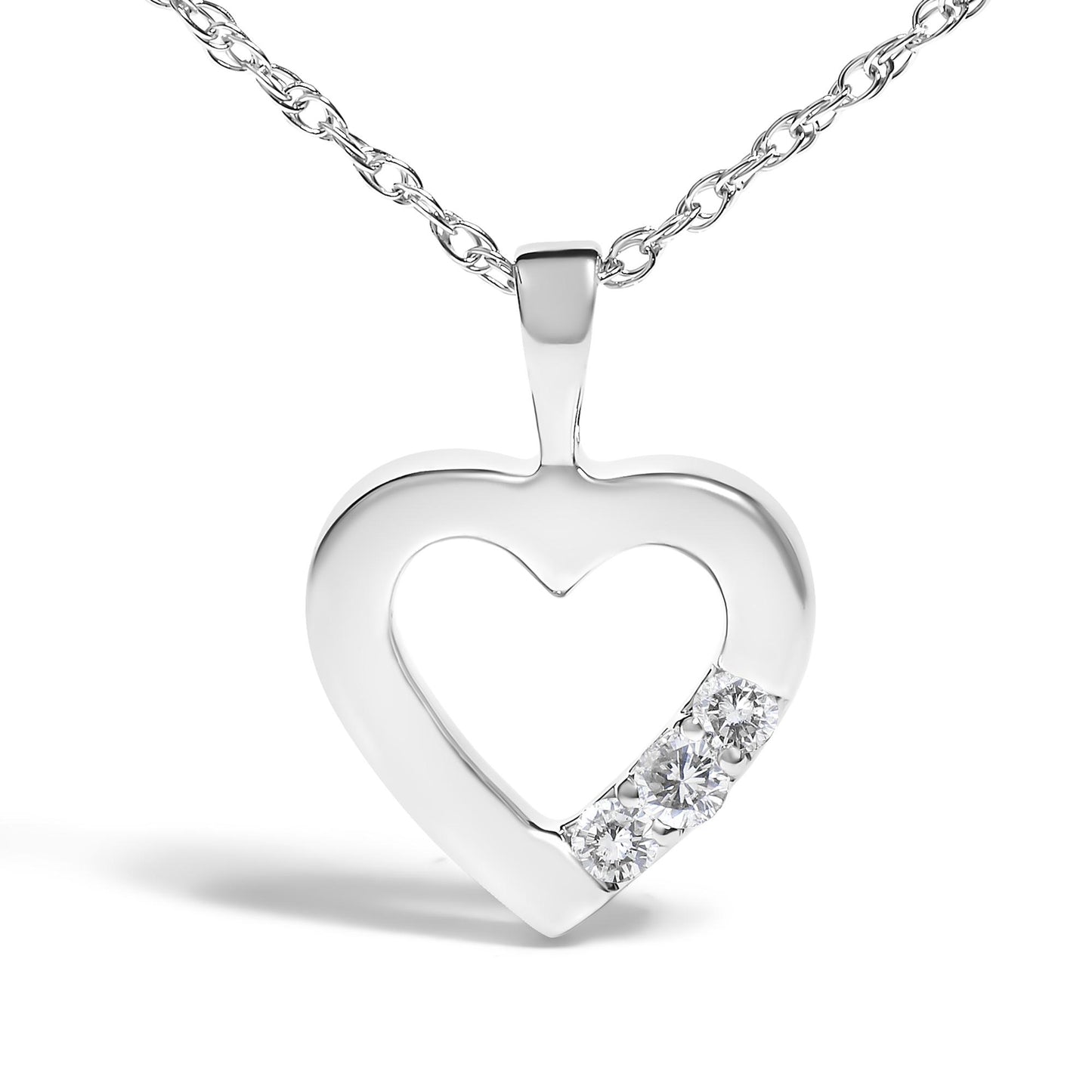 White metal heart-shaped pendant necklace with three prong-set round white gemstones, front angle.