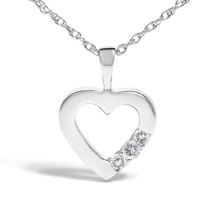White metal heart-shaped pendant necklace with three prong-set round white gemstones, front angle.