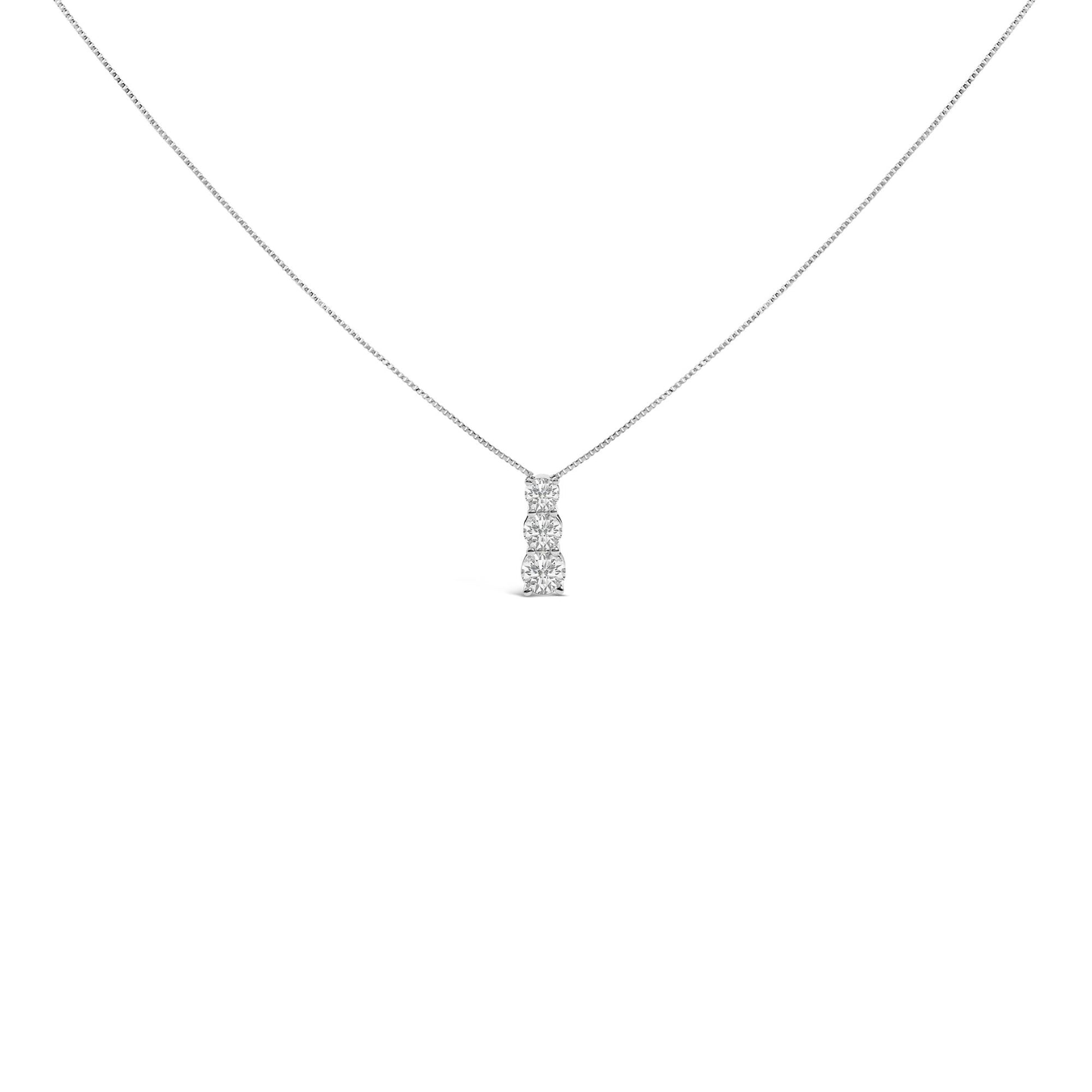 Front view of a white necklace with a vertical pendant featuring three round white gemstones in a shared prong setting.