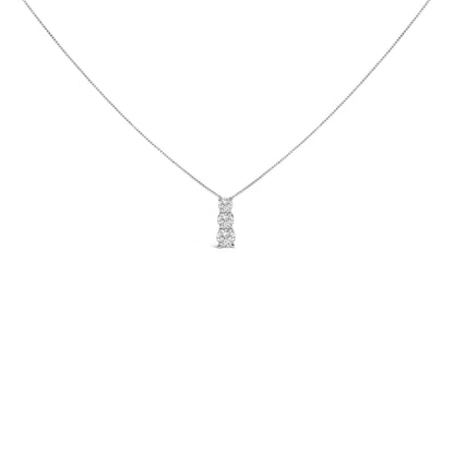 Front view of a white necklace with a vertical pendant featuring three round white gemstones in a shared prong setting.