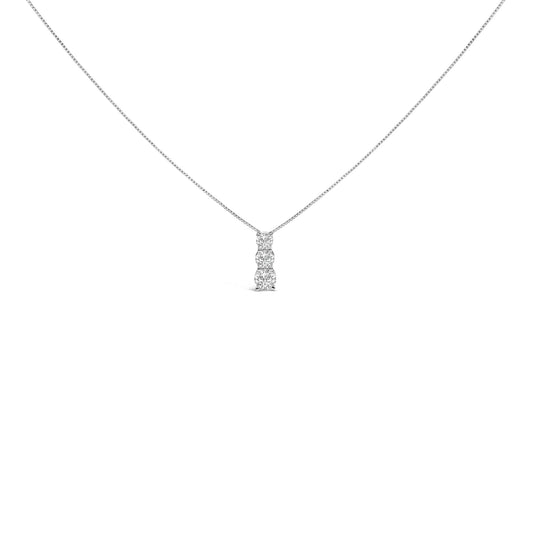 Front view of a white necklace with a vertical pendant featuring three round white gemstones in a shared prong setting.