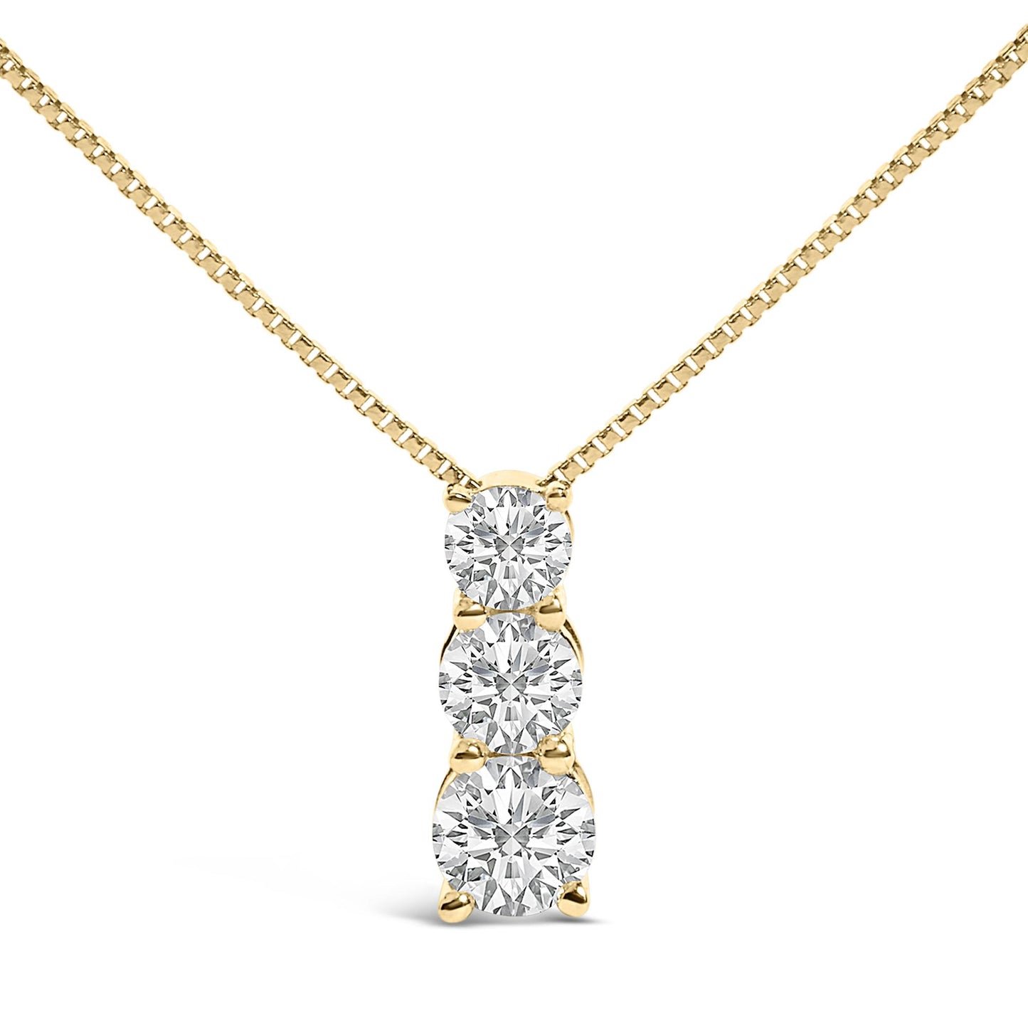 Close-up front view of a yellow metal necklace with a vertical pendant featuring three round white gemstones in a shared prong setting.