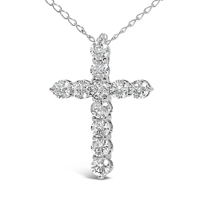 Close-up front view of a white metal necklace featuring a cross-shaped pendant with round white gemstones in shared prong settings.