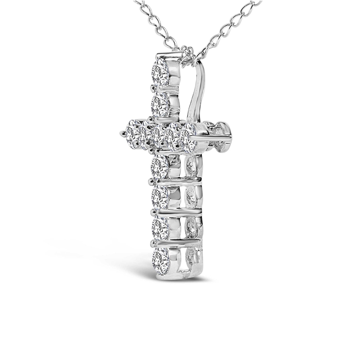 Close-up front angle of a white metal cross necklace pendant featuring round white gemstones in a shared prong setting, suspended on a linked chain.