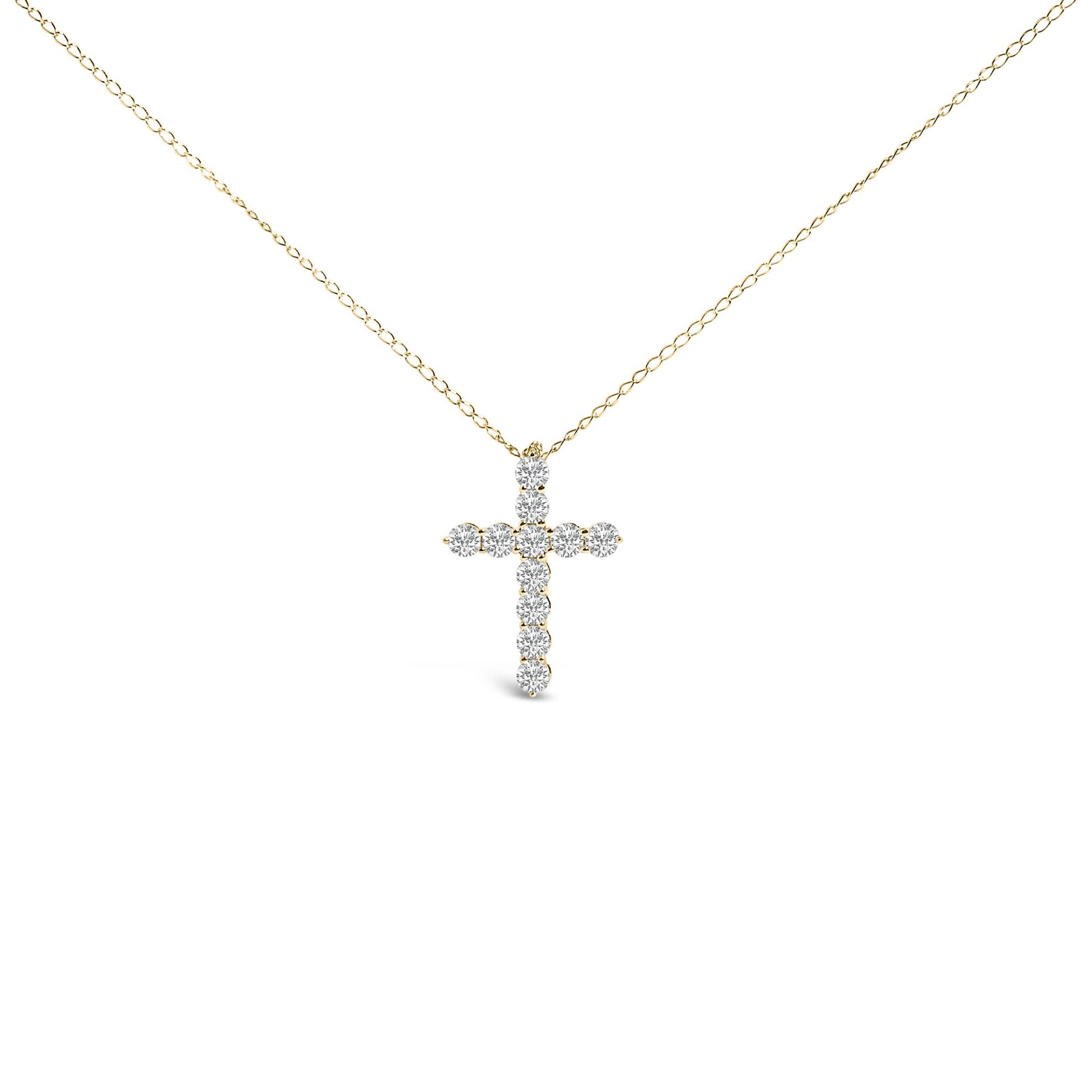 Front-facing shot of a yellow metal necklace with a cross-shaped pendant featuring round white gemstones in a shared prong setting.
