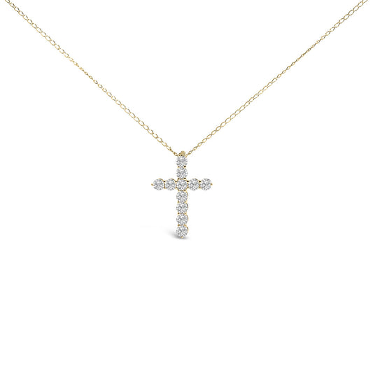 Front-facing shot of a yellow metal necklace with a cross-shaped pendant featuring round white gemstones in a shared prong setting.