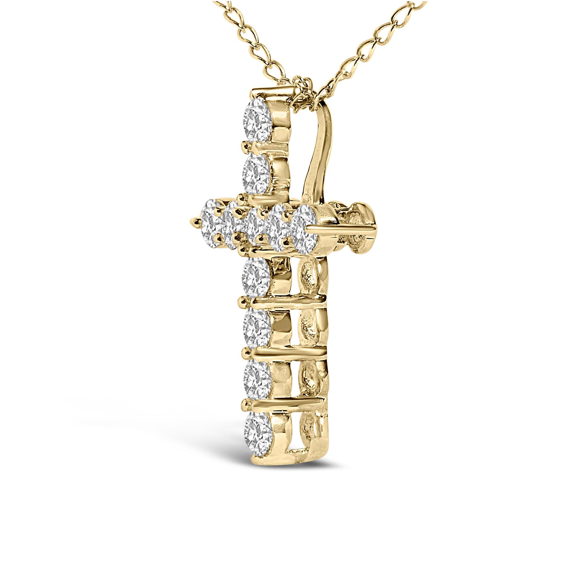 Close-up front angle of a yellow metal cross-shaped necklace pendant with round white gemstones set in shared prong settings, shown on a chain against a white background.