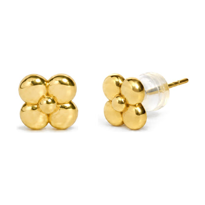 Close-up front and side view of a single pair of yellow metal stud earrings in a four-petal flower shape, with a clear backing shown on the side.