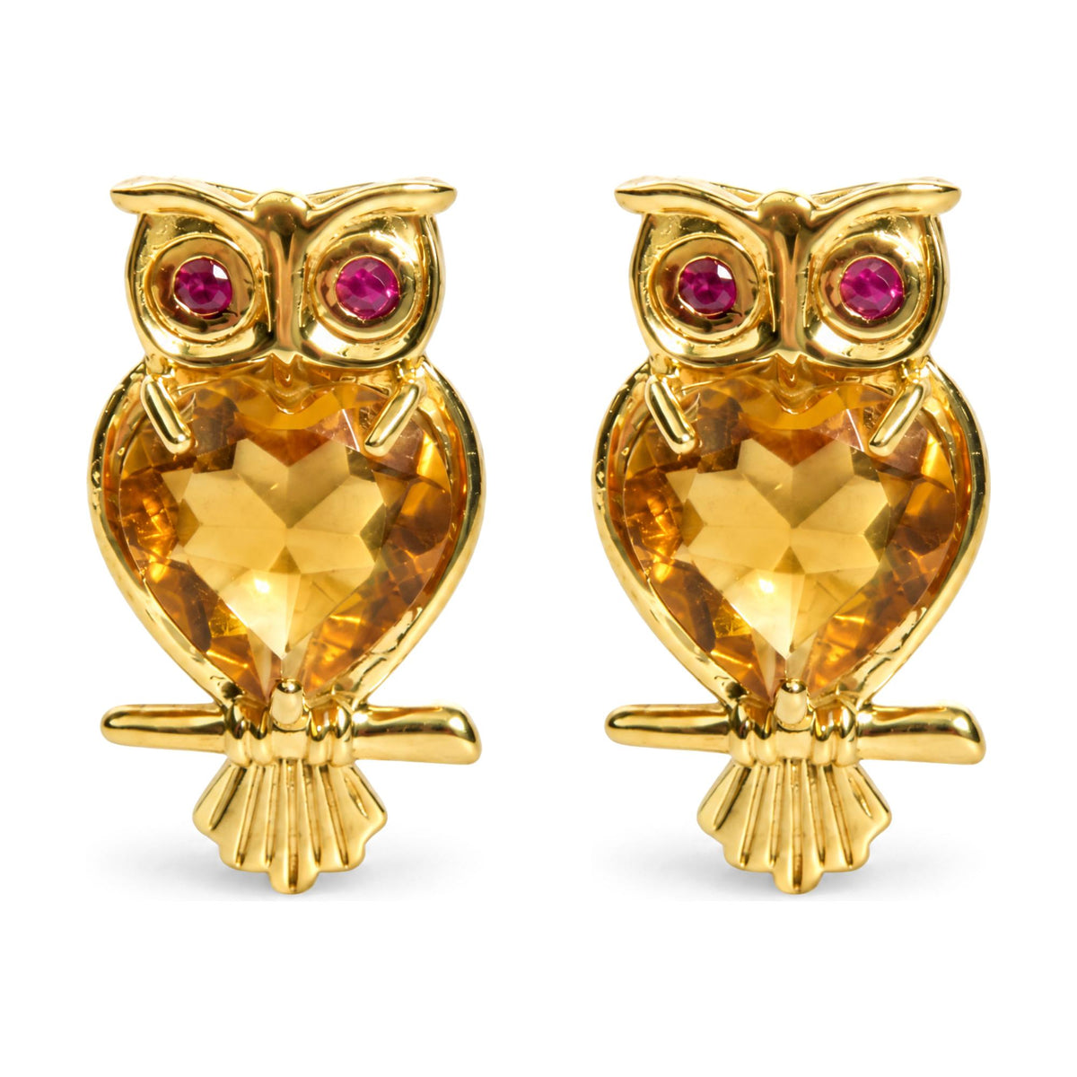 Close-up front view of owl-shaped yellow metal earrings with heart-shaped yellow gemstones as the body and round red gemstones as the eyes, shown on a white background.