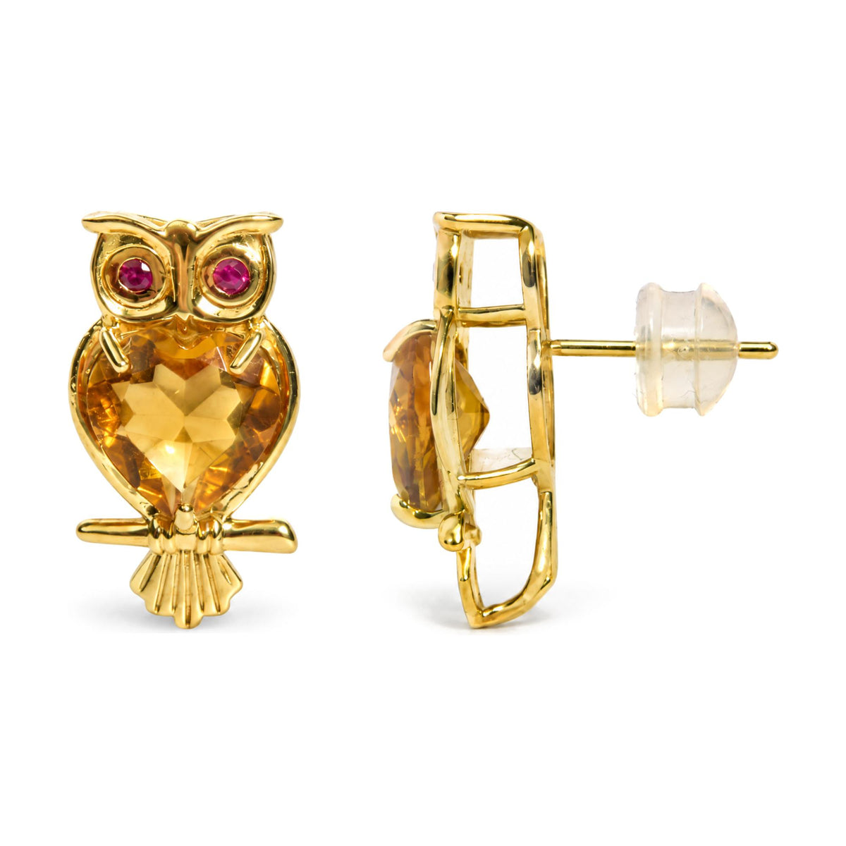 Close-up front and side view of yellow metal owl-shaped earrings with heart-shaped yellow gemstones and round red gemstones, shown on a white background.