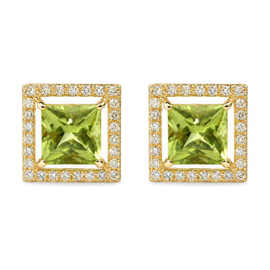 Close-up front angle of a pair of yellow metal square-shaped earrings featuring a large green princess-cut gemstone in the center, surrounded by small round white gemstones in prong settings.