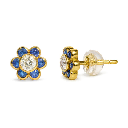 Close-up front and side angle of a single yellow metal flower-shaped stud earring with a white gemstone center and blue gemstones forming petals, shown on a white background.