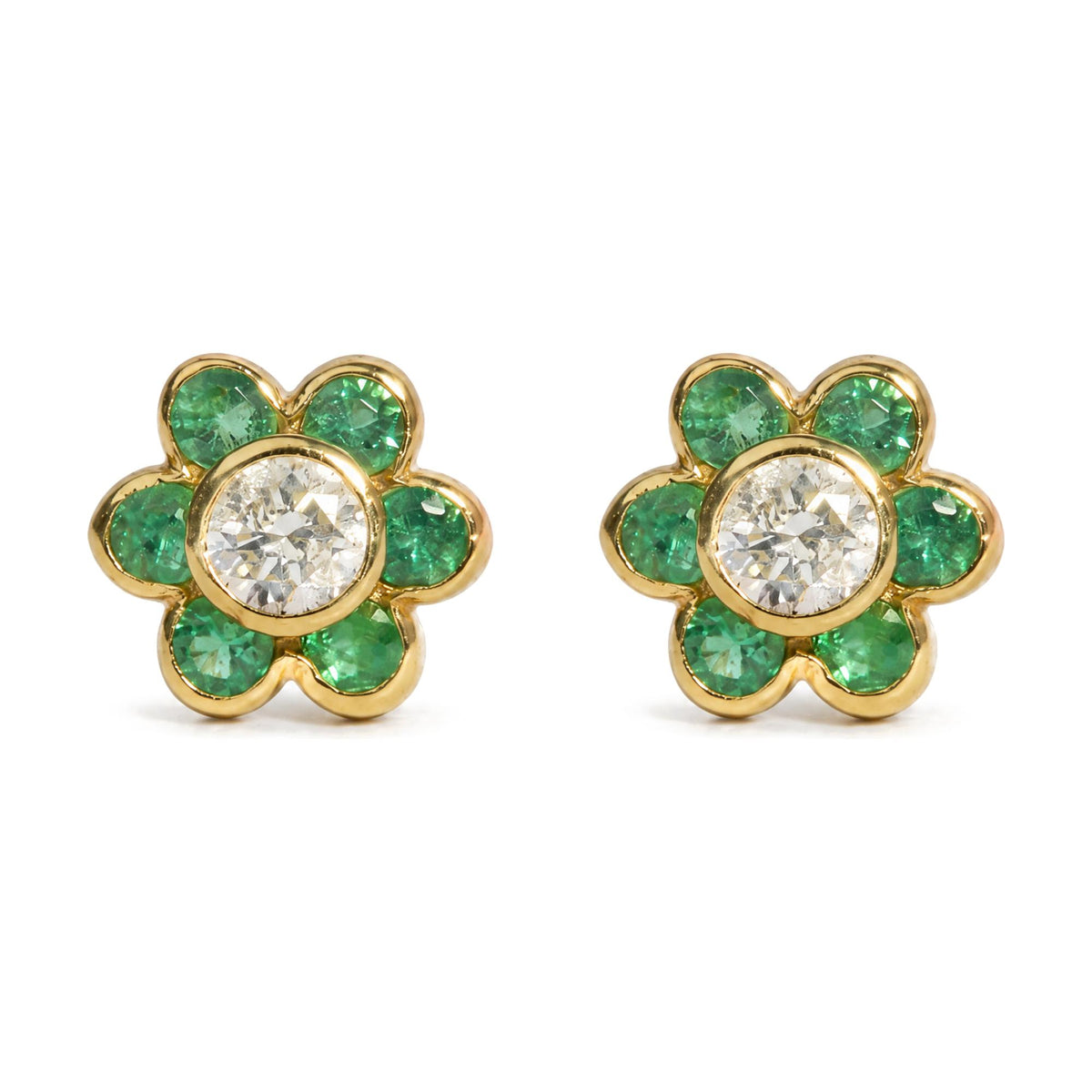Close-up front angle of a pair of yellow metal flower-shaped earrings with round white gemstones in the center and round green gemstones forming the petals, shown on a white background.