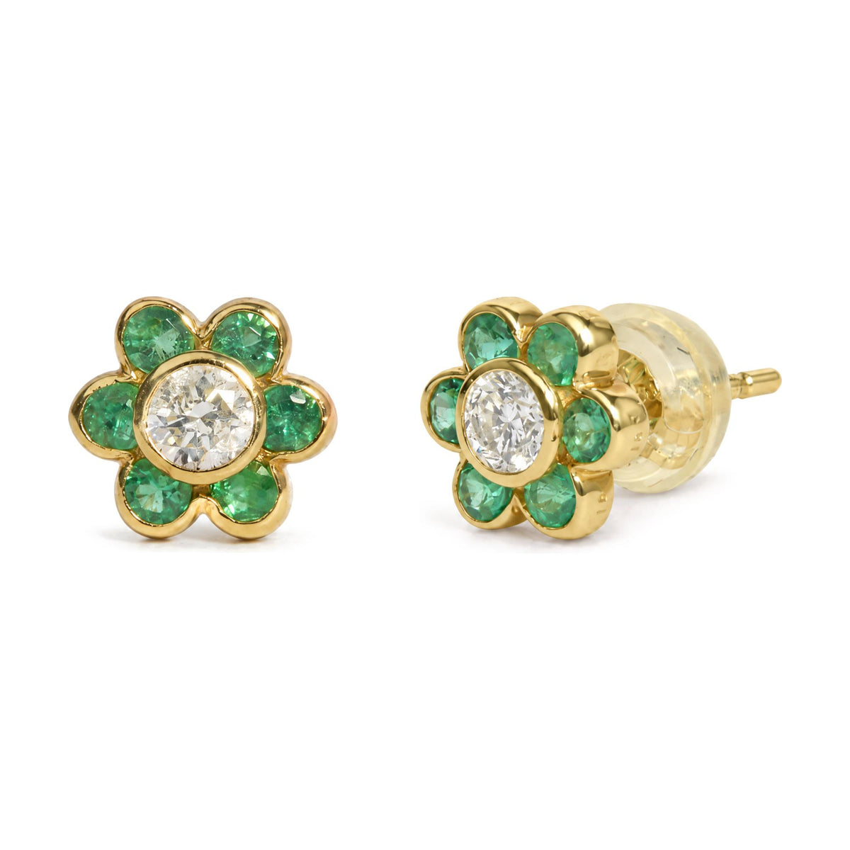 Close-up front and side angle view of yellow metal flower-shaped stud earrings with a central round white gemstone and surrounding round green gemstones in bezel settings shown on a white background.