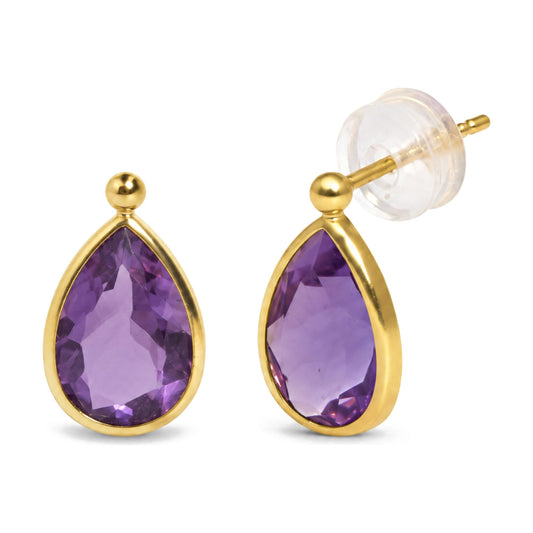 Close-up front angle of yellow metal earrings with pear-shaped purple gemstones in bezel settings.