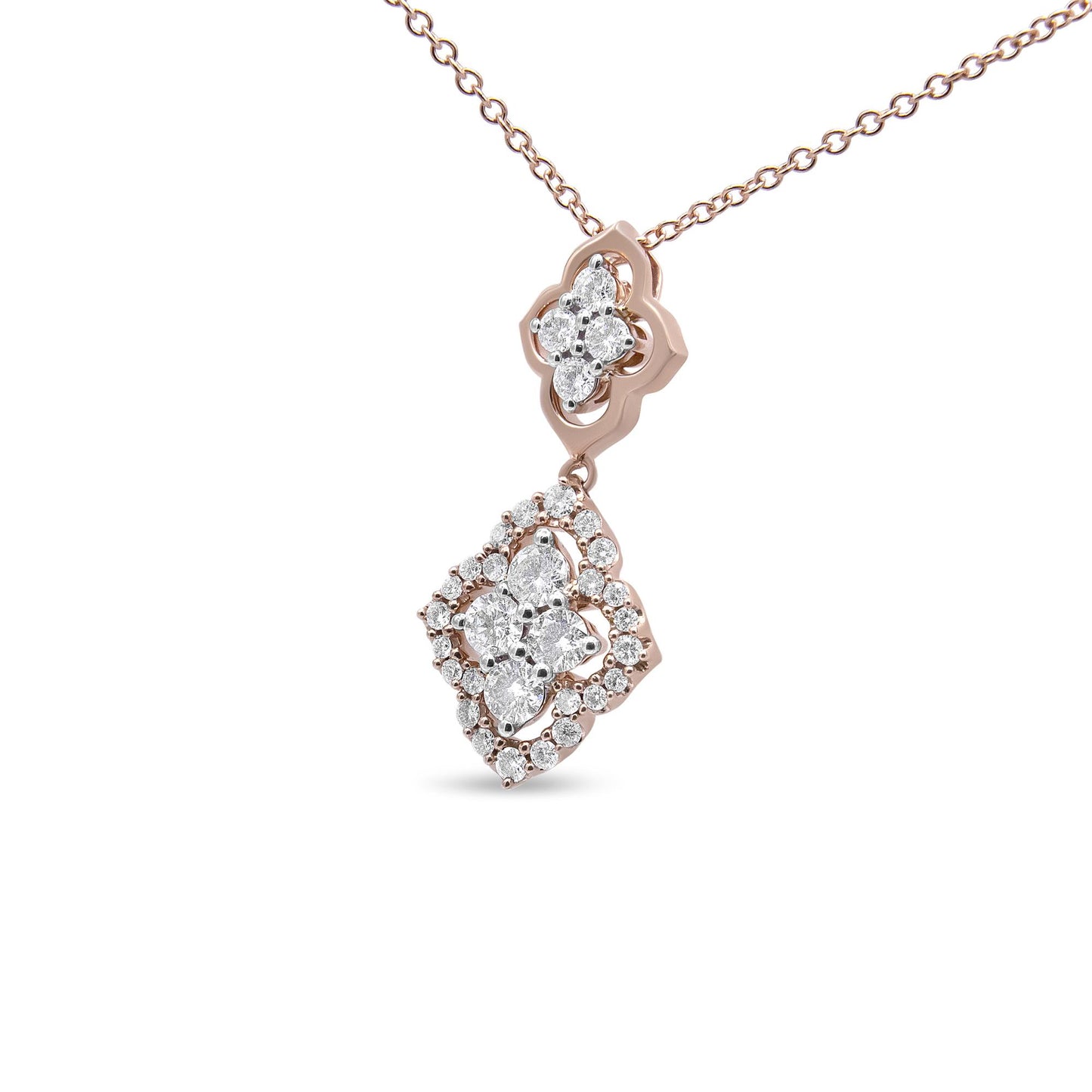 Close-up angled shot of a rose metal necklace with a pendant featuring clusters of round white gemstones set in shared prong settings.