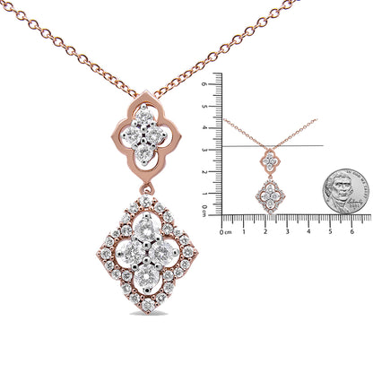 Rose metal color necklace with two floral-shaped pendants adorned with white round gemstones in shared prong settings, shown from the front with a small scale and coin for size reference.
