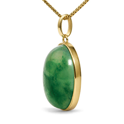 Close-up front angle of a yellow metal necklace with an oval-shaped green gemstone in bezel setting.