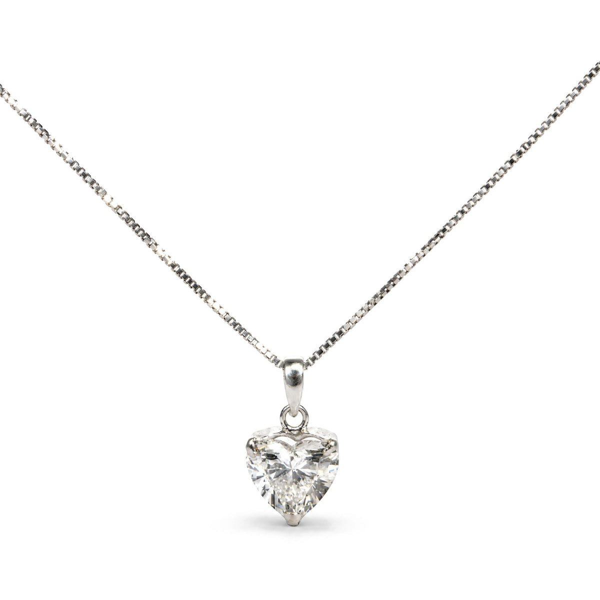 Close-up front view of a white necklace with a heart-shaped white gemstone pendant in a three-prong setting.