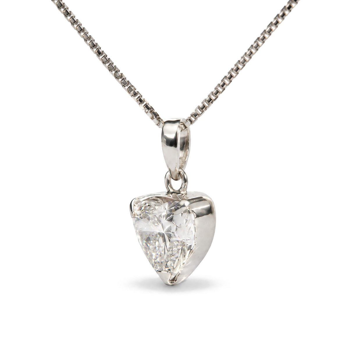Close-up front view of a white necklace chain featuring a heart-shaped pendant with a white gemstone in a three-prong setting.