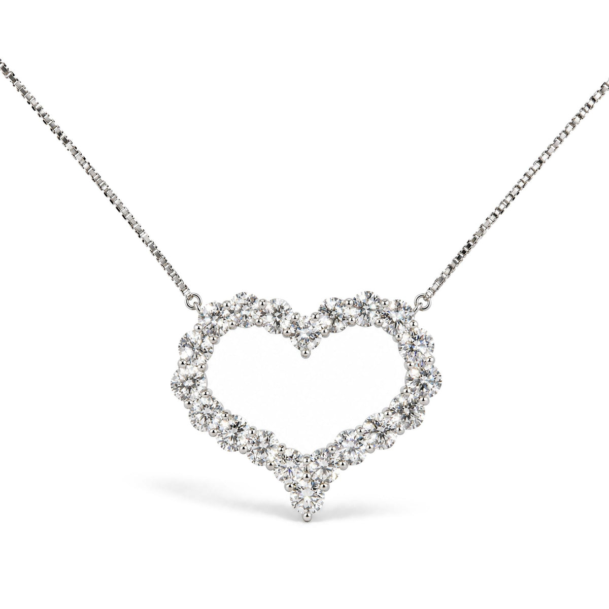 Close-up front view of a white metal necklace with a heart-shaped pendant made of round white gemstones in prong settings.