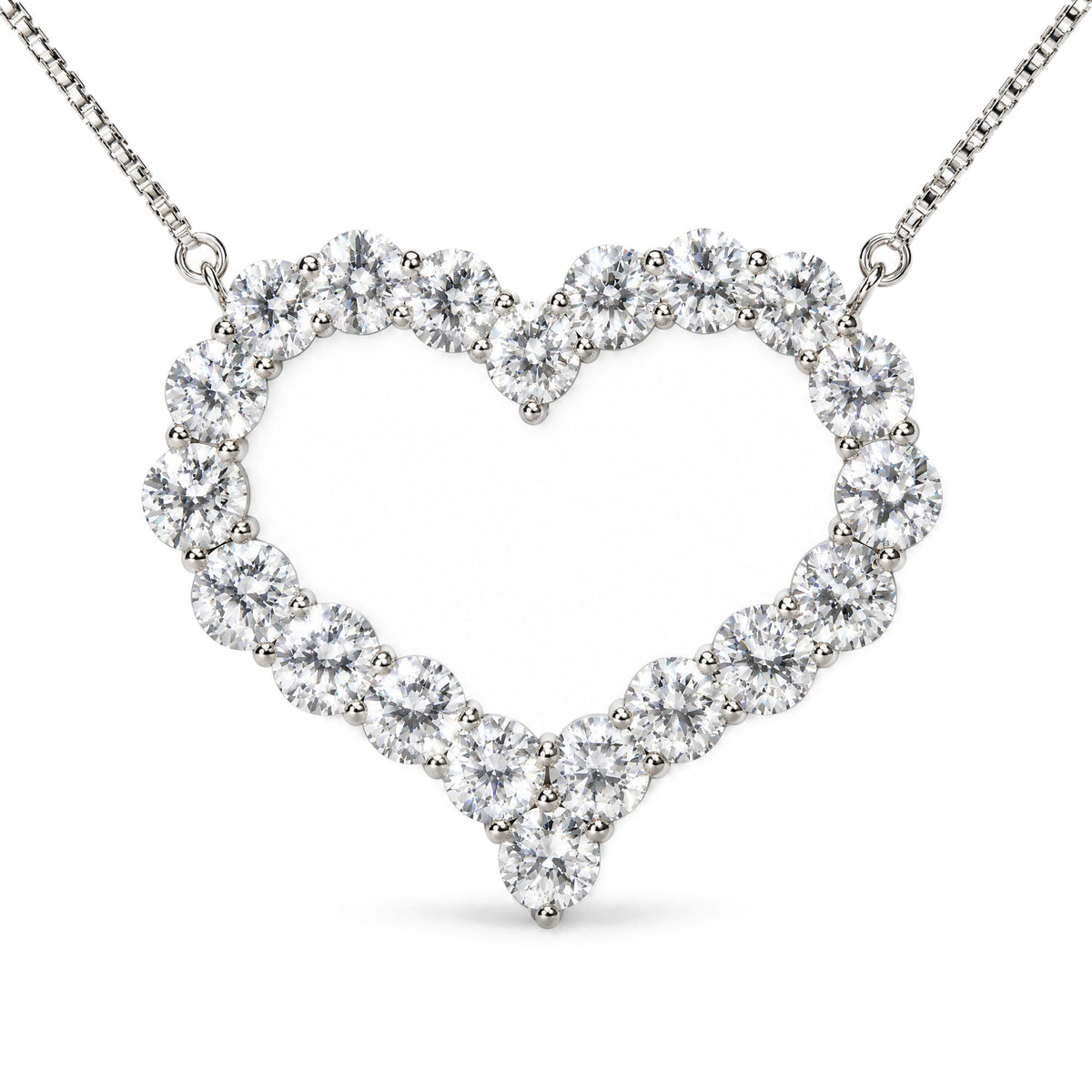 Close-up front view of a white metal heart-shaped necklace adorned with round white gemstones in prong settings on a chain.