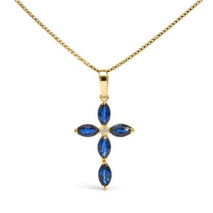 Close-up front view of a yellow metal cross-shaped necklace pendant with marquise-shaped blue gemstones and a round white gemstone center, shown on a white background.