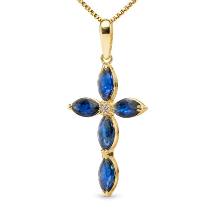 Close-up front view of a yellow metal necklace pendant in the shape of a cross with five blue marquise-shaped gemstones and one round white gemstone in the center.
