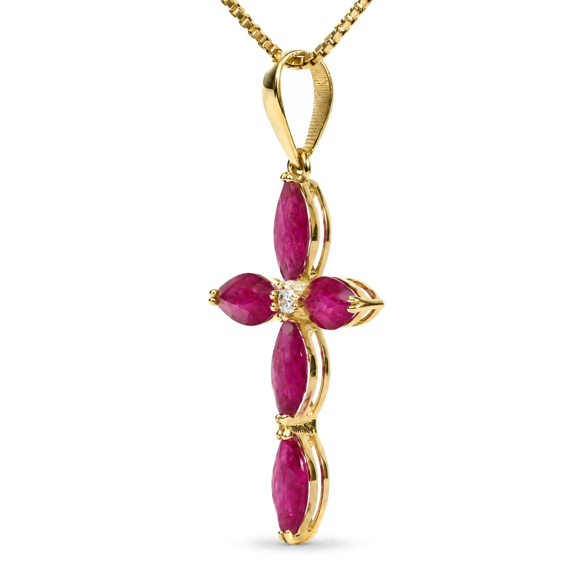 Close-up front view of a yellow metal necklace pendant in the shape of a cross, featuring marquise-shaped red gemstones and a round white gemstone in the center, shown on a white background.