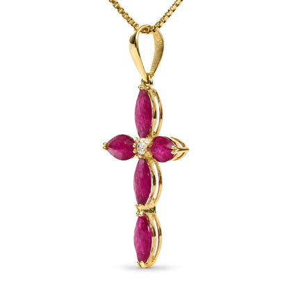Close-up front view of a yellow metal necklace pendant in the shape of a cross, featuring marquise-shaped red gemstones and a round white gemstone in the center, shown on a white background.