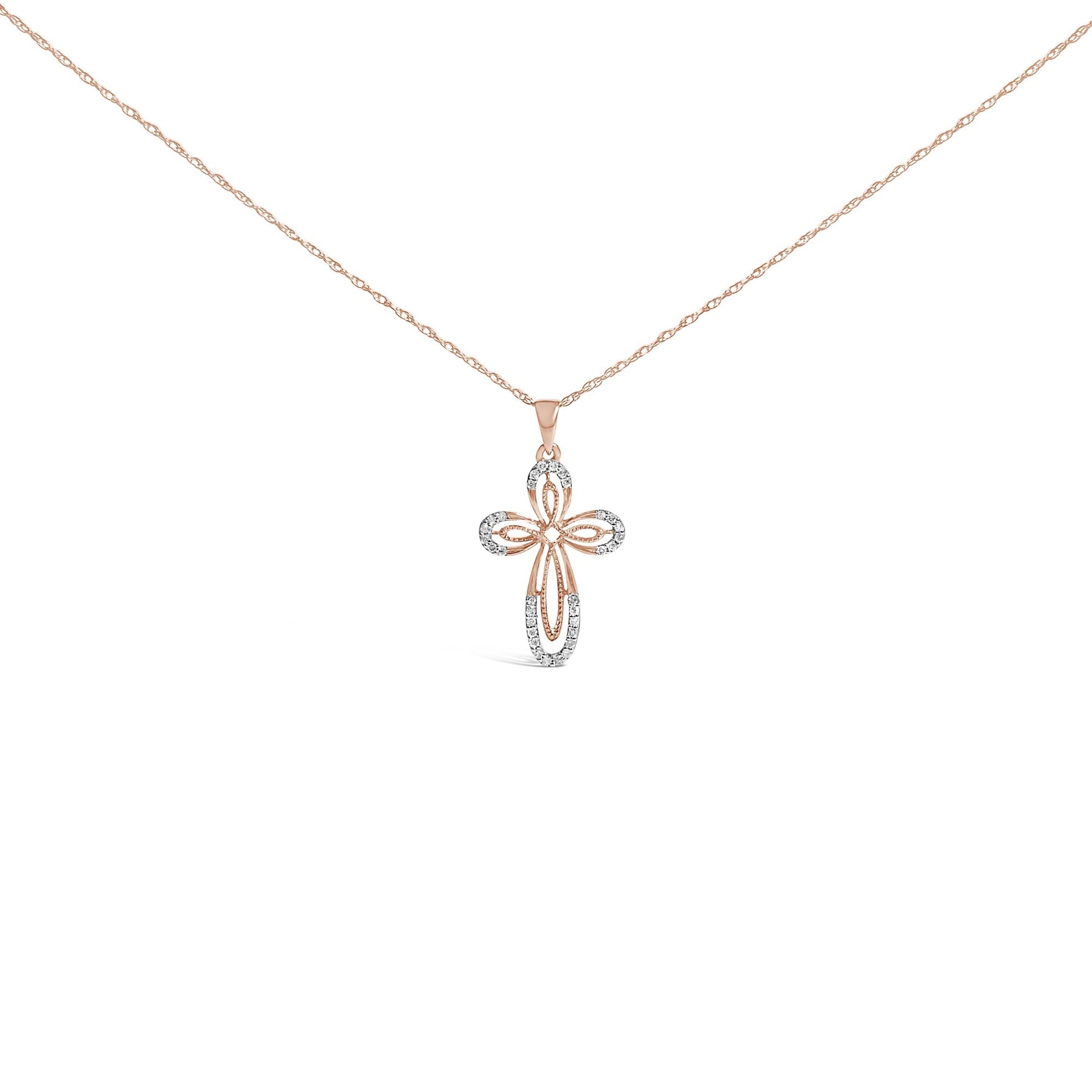 Front-facing shot of a rose metal necklace with a cross-shaped pendant featuring white round gemstones in prong settings.