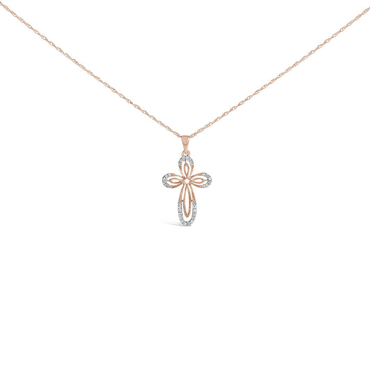 Front-facing shot of a rose metal necklace with a cross-shaped pendant featuring white round gemstones in prong settings.
