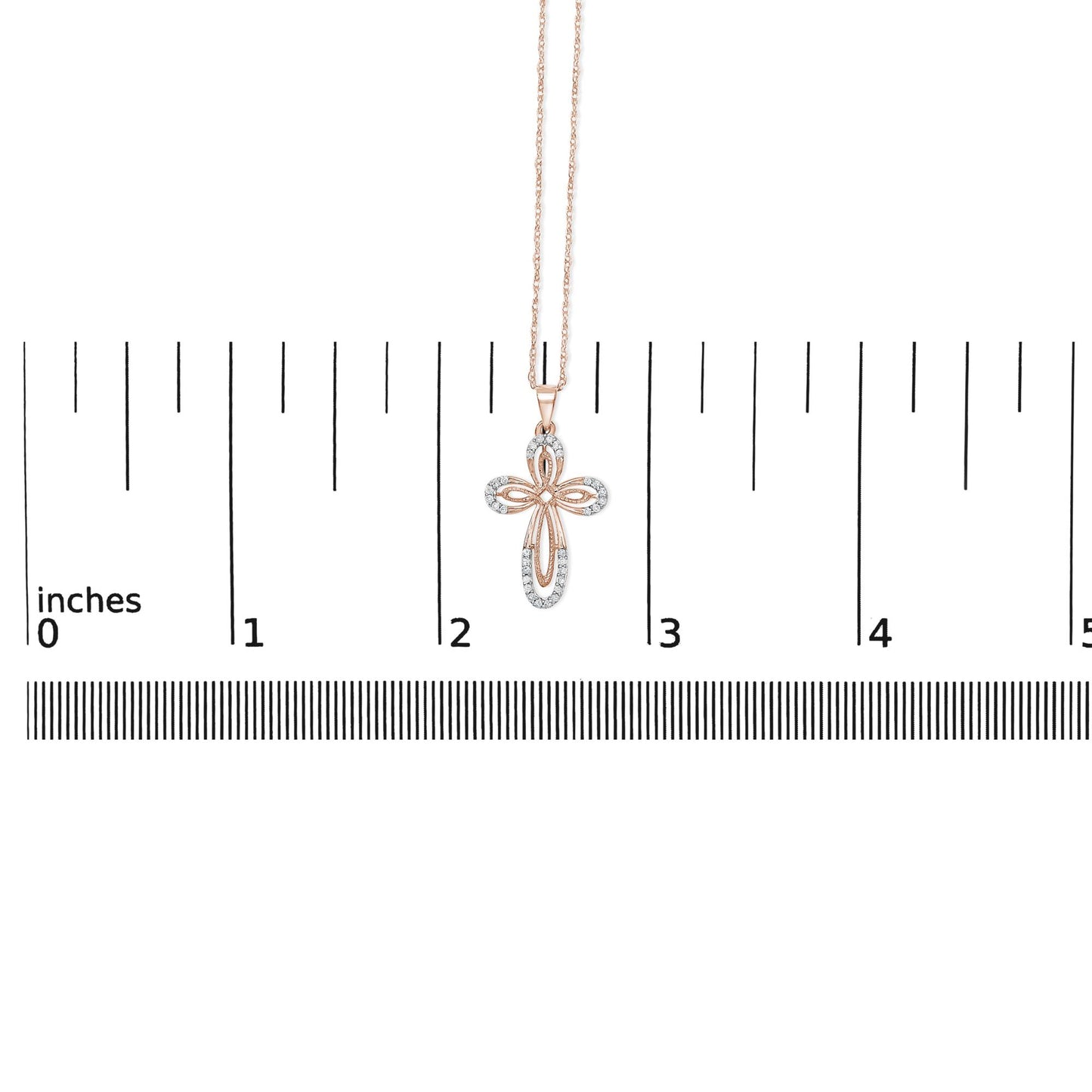 Rose-colored necklace with a cross-shaped pendant featuring round white gemstones in prong settings, shown hanging against a ruler scale, front view.
